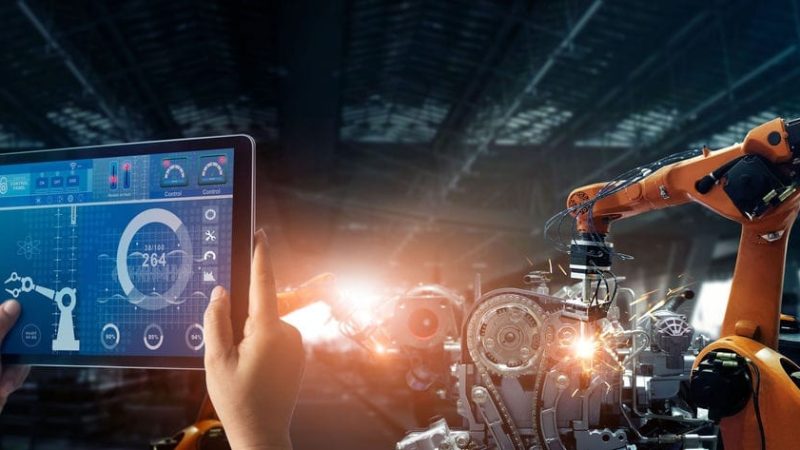 Engineer check and control welding robotics automatic arms machine in intelligent factory automotive industrial with monitoring system software. Digital manufacturing operation. Industry 4.0