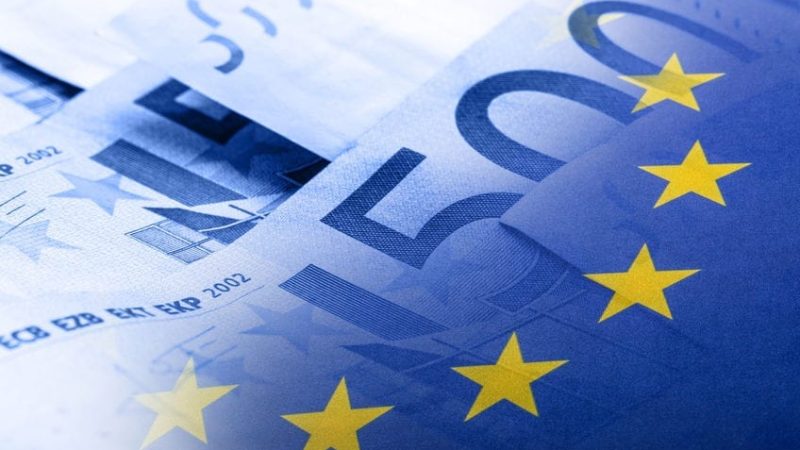 Euro flag. Euro money. Euro currency. Colorful waving european union flag on a euro money background.